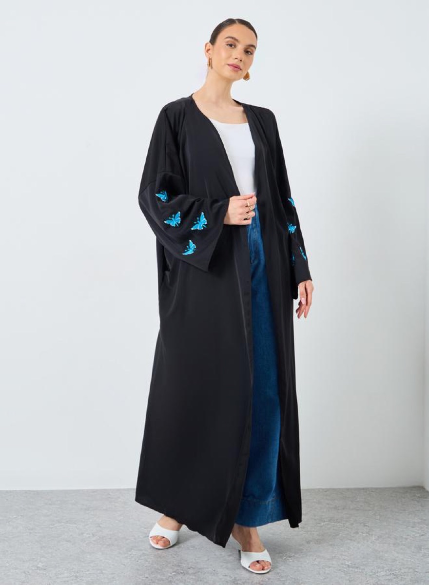 Model wearing a black butterfly sleeve abaya