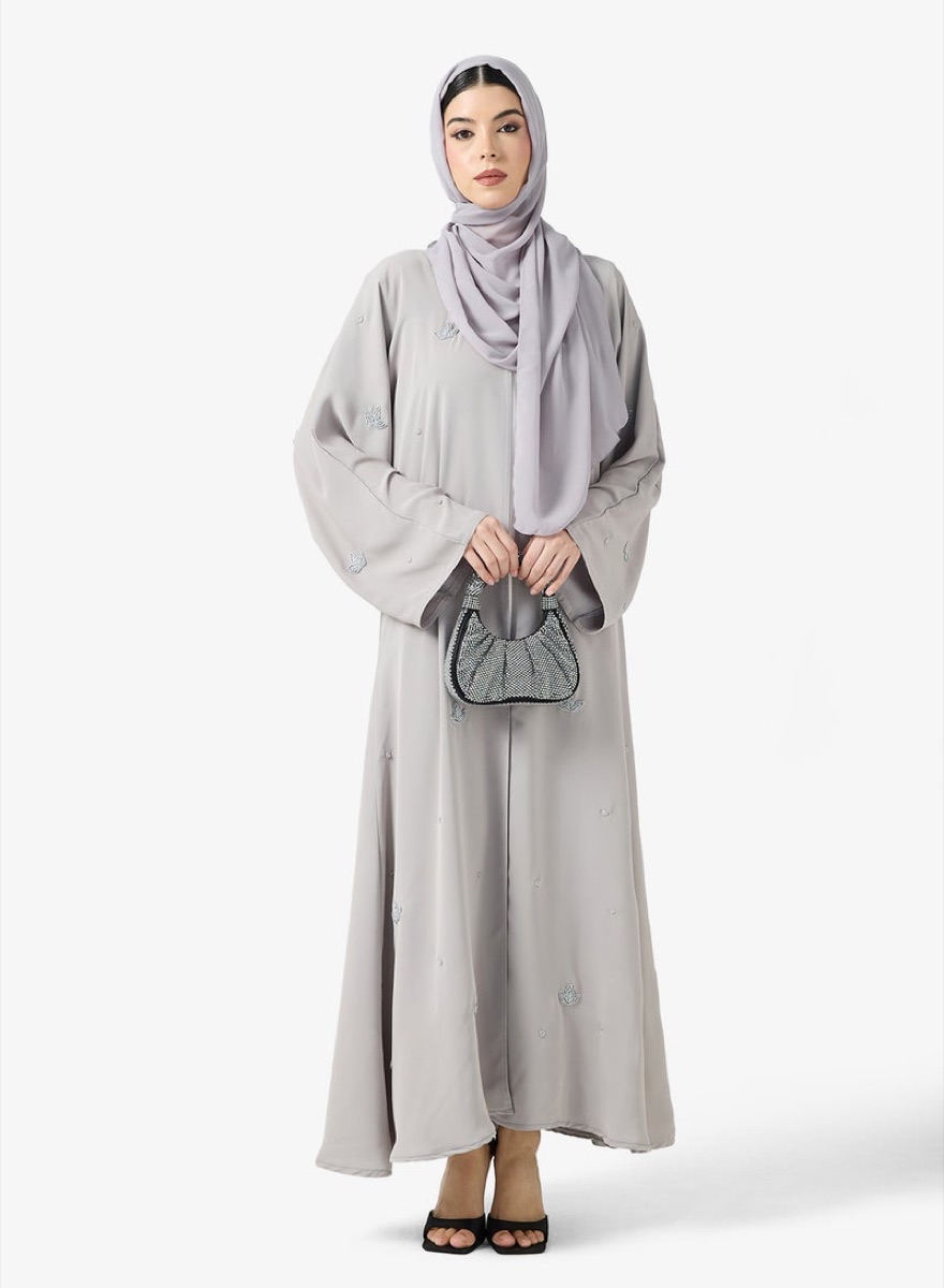Model wearing a grey embellished abaya and sheila
